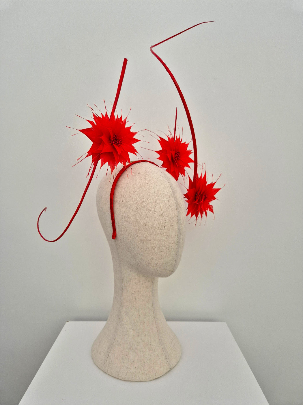 side view red feather flower headpiece with floating quills