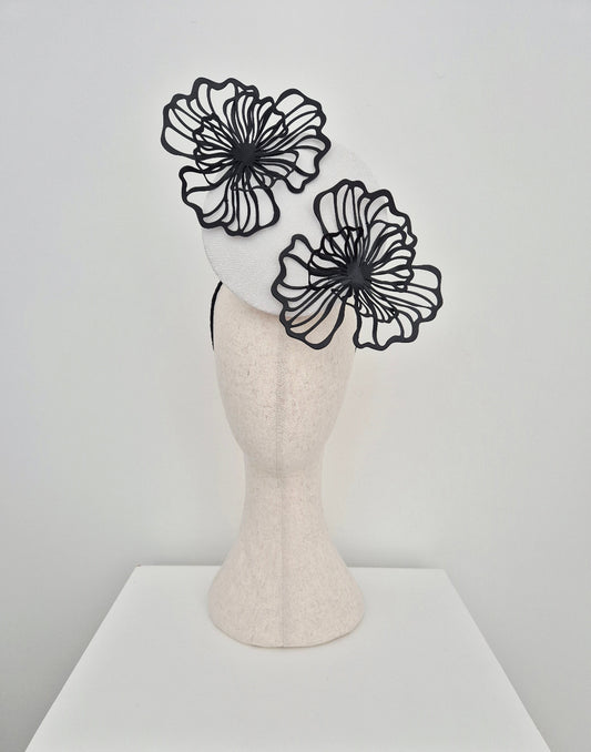 white percher headpiece with black flowers