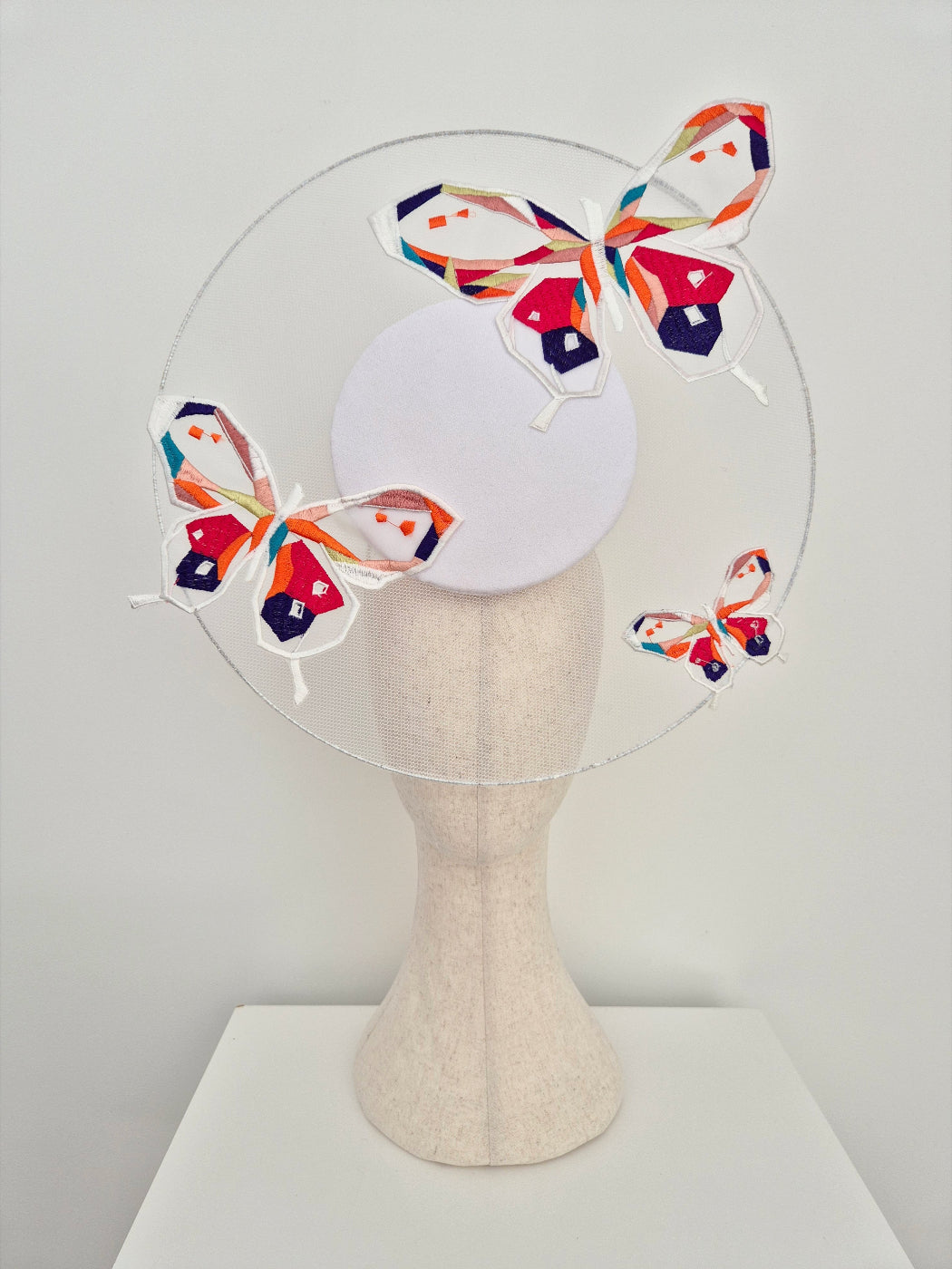 white percher headpiece with butterflies