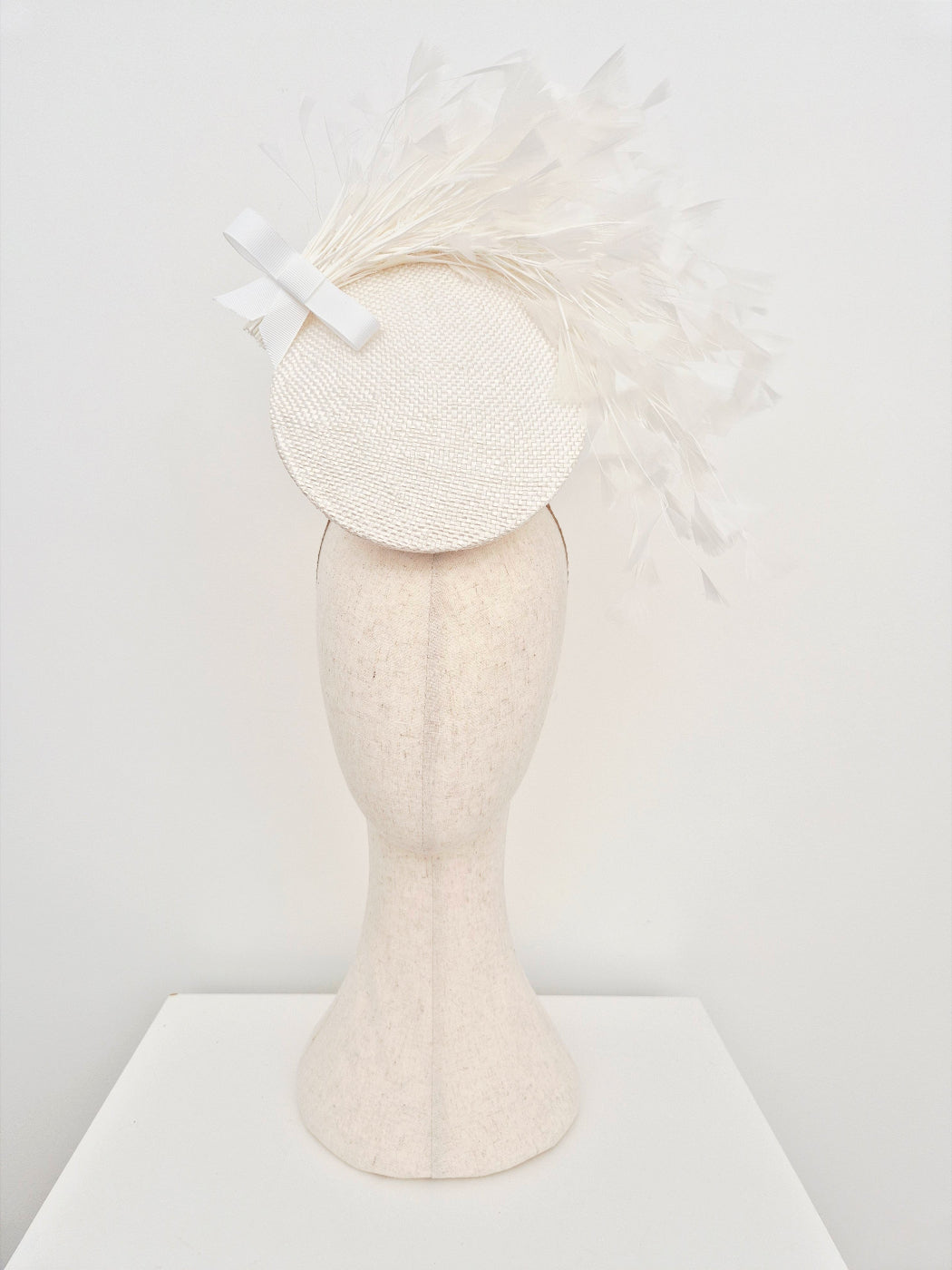 white straw percher headpiece with feathers